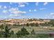 Scenic view featuring a natural rock formation with green vegetation and a vibrant blue sky at 11064 Hermitage Run, Littleton, CO 80125