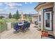 Spacious patio with outdoor dining set, grill, and well-maintained landscaping for outdoor enjoyment at 11064 Hermitage Run, Littleton, CO 80125