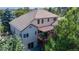 An aerial view showcases a private deck, lush landscaping, and the architectural details of the home's unique backyard space at 1977 Champions Cir, Castle Rock, CO 80104