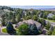 Expansive aerial view of the property surrounded by lush greenery and mountain views at 1977 Champions Cir, Castle Rock, CO 80104