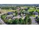 Stunning aerial view of luxury homes nestled amongst mature trees and located on the golf course at 1977 Champions Cir, Castle Rock, CO 80104