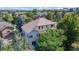 Bird's eye view of a home nestled among mature trees, featuring a spacious yard and a charming neighborhood setting at 1977 Champions Cir, Castle Rock, CO 80104