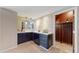 Bar area featuring dark cabinets, a wine cooler, and a wine storage room at 1977 Champions Cir, Castle Rock, CO 80104