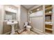 Bathroom featuring a pedestal sink, toilet, and a walk-in shower with built in shelving at 1977 Champions Cir, Castle Rock, CO 80104