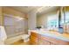 Bright bathroom featuring a tub-shower combo, natural wood vanity, and bright finishes at 1977 Champions Cir, Castle Rock, CO 80104