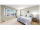 Bright bedroom with natural light features a large window, plush carpet, and neutral decor at 1977 Champions Cir, Castle Rock, CO 80104