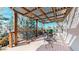 Inviting deck with a wood-lattice cover over an outdoor kitchen with a built-in gas grill and room for entertaining at 1977 Champions Cir, Castle Rock, CO 80104