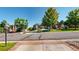 Charming brick home with a well-maintained lawn and mature trees, presenting a welcoming curb appeal in a neighborhood setting at 1977 Champions Cir, Castle Rock, CO 80104