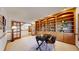 Home office with custom built-in shelving, french doors, and plenty of natural light at 1977 Champions Cir, Castle Rock, CO 80104