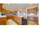 Gourmet kitchen features wood cabinets, hardwood floors, an island cooktop, and desk area at 1977 Champions Cir, Castle Rock, CO 80104
