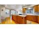 Spacious kitchen with a large center island, hardwood floors and open concept design at 1977 Champions Cir, Castle Rock, CO 80104
