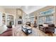 Cozy living room with fireplace, vaulted ceiling, and large windows at 1977 Champions Cir, Castle Rock, CO 80104
