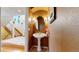 Charming powder room with pedestal sink and decorative mirror, with entryway leading to the stairs at 1977 Champions Cir, Castle Rock, CO 80104