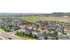 Expansive aerial view of modern homes in a well-planned community with green spaces and mountain views at 6387 Agave Ave, Castle Rock, CO 80108