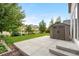 Landscaped backyard with shed, patio, and green lawn at 6387 Agave Ave, Castle Rock, CO 80108