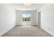 Bright bedroom featuring neutral carpet, a window view, and white trim at 6387 Agave Ave, Castle Rock, CO 80108