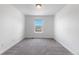 Bright bedroom featuring neutral carpet, a window view, and white trim at 6387 Agave Ave, Castle Rock, CO 80108