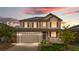 Charming two-story home featuring a well-manicured lawn, solar panels, and inviting curb appeal at sunset at 6387 Agave Ave, Castle Rock, CO 80108