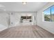 Sunlit open-concept living room flows into a modern kitchen with stainless steel appliances and granite countertops at 6387 Agave Ave, Castle Rock, CO 80108