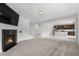 Open-concept living room with a fireplace that flows into a modern kitchen with granite countertops at 6387 Agave Ave, Castle Rock, CO 80108