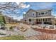 Well-manicured backyard with rock garden, patio area, and tasteful landscaping at 6746 S Biloxi Ct, Aurora, CO 80016
