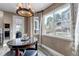 Bright breakfast nook area featuring a large window with a view of the backyard and stylish chandelier at 6746 S Biloxi Ct, Aurora, CO 80016