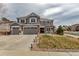 Charming two-story home with a well-manicured lawn and a three-car garage at 6746 S Biloxi Ct, Aurora, CO 80016