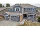 Front aerial view of a two-story home with a well-kept lawn and a porch at 6746 S Biloxi Ct, Aurora, CO 80016
