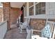 Charming front porch with white rocking chairs, stone accents, and stylish decor at 6746 S Biloxi Ct, Aurora, CO 80016