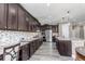 Stylish kitchen with stainless steel appliances, granite countertops, mosaic backsplash, and a large center island at 6746 S Biloxi Ct, Aurora, CO 80016