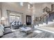 Elegant living space with high ceilings, staircase, and natural light, creating a welcoming atmosphere at 6746 S Biloxi Ct, Aurora, CO 80016