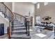 Bright living room with high ceilings, large windows, and modern staircase at 6746 S Biloxi Ct, Aurora, CO 80016