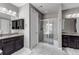 Beautiful bathroom with separate vanities, granite countertops, tiled shower with glass door, and white tile flooring at 6746 S Biloxi Ct, Aurora, CO 80016