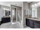 Beautiful bathroom with separate vanities, granite countertops, tiled shower with glass door, and soaking tub at 6746 S Biloxi Ct, Aurora, CO 80016