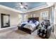 Spacious main bedroom with large bed, massage chair, and tray ceiling with fan at 6746 S Biloxi Ct, Aurora, CO 80016