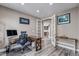 Bright home office with wood flooring, desk and chair, and french doors leading to the kitchen at 6746 S Biloxi Ct, Aurora, CO 80016