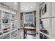 Charming home office featuring custom built-in shelving and a large window with a view of the outdoors at 6746 S Biloxi Ct, Aurora, CO 80016
