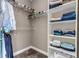 Walk-in closet with custom shelving for storing clothes, hats, and accessories at 6746 S Biloxi Ct, Aurora, CO 80016