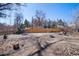 Expansive backyard with wooden fence, a fire pit and potential for landscaping at 2154 S Joplin Way, Aurora, CO 80013