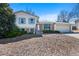 Split-level home with brick and siding, complimented by mature landscaping and a welcoming facade at 2154 S Joplin Way, Aurora, CO 80013