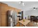 Bright open kitchen with stainless steel appliances, light wood cabinets and adjacent dining area at 2154 S Joplin Way, Aurora, CO 80013
