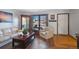Cozy living room featuring hardwood floors, a large window, and comfortable seating at 2154 S Joplin Way, Aurora, CO 80013