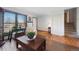 Bright living room with hardwood floors, a large window, and access to the staircase at 2154 S Joplin Way, Aurora, CO 80013