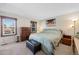 Comfortable bedroom with natural light, dresser, bench and carpet flooring at 2154 S Joplin Way, Aurora, CO 80013