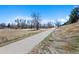 Paved walking path surrounded by natural landscape, perfect for leisurely strolls and outdoor activities at 2154 S Joplin Way, Aurora, CO 80013