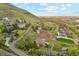 Scenic aerial shot of hillside neighborhood with homes nestled among lush trees and rolling terrain at 4305 Easley Rd, Golden, CO 80403