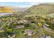 Expansive aerial view showcasing residences nestled amidst rolling hills, mature trees, and winding roads at 4305 Easley Rd, Golden, CO 80403