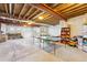 Spacious unfinished basement with exposed ceiling, a ping pong table, and space for recreation and storage at 4305 Easley Rd, Golden, CO 80403