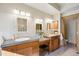 Bright bathroom featuring double sinks, wood cabinets, concrete countertops, and a decorative glass block window at 4305 Easley Rd, Golden, CO 80403