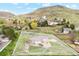 Expansive single-story home showcasing well-kept lawn, mature trees, and mountainous scenery at 4305 Easley Rd, Golden, CO 80403